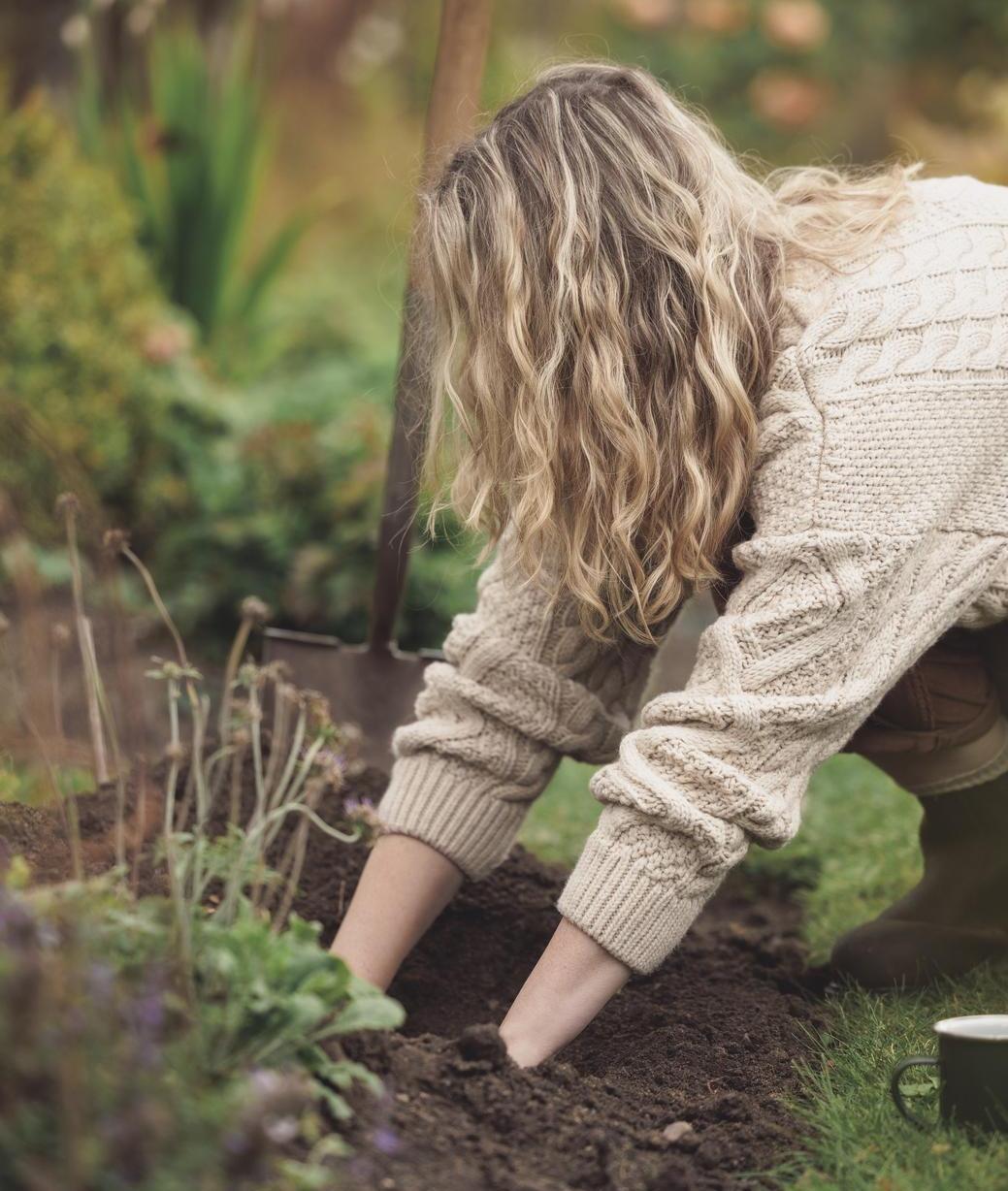 Woman with her hands in soil