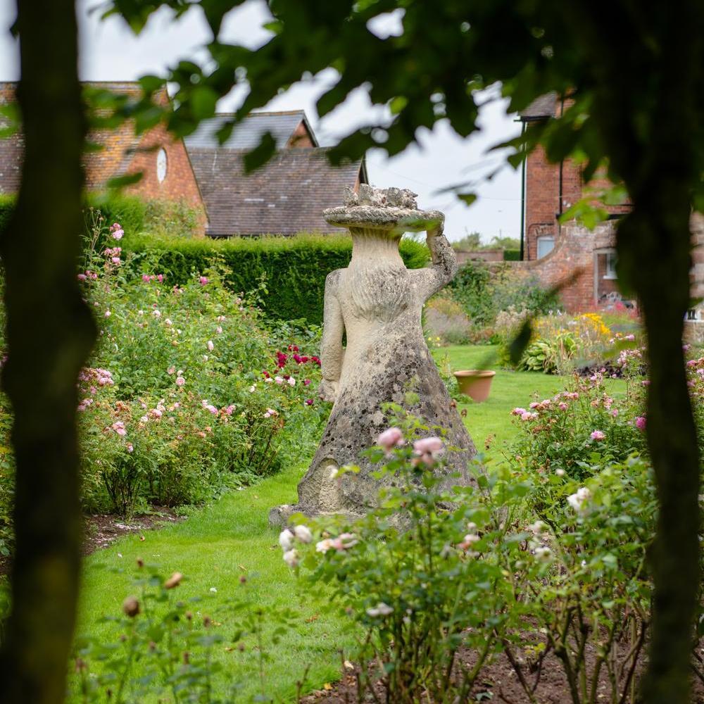 Stone sculpture designed by Pat Austin, David Austin's wife, in their home and gardens in Shropshire.